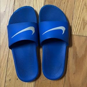 Blue and grey Nike slides